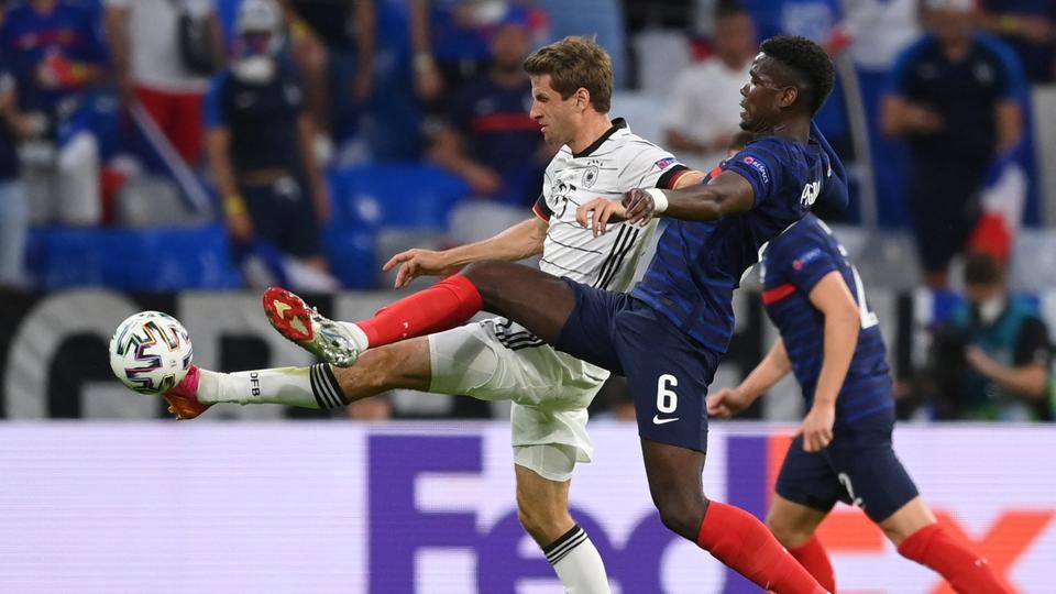 Germany's forward Thomas Mueller (L) is marked by France's midfielder Paul Pogba during the match between France and Germany in Munich on June 15, 2021.