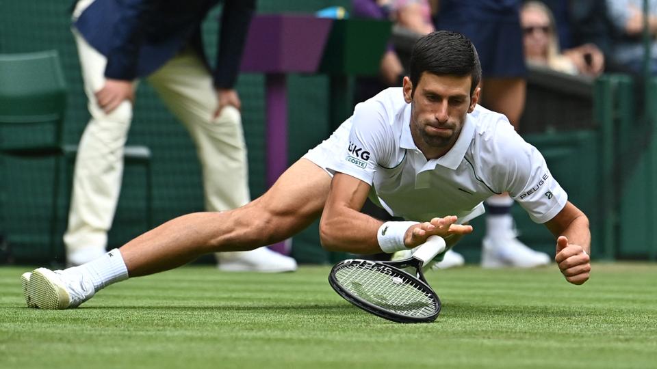 Serbia's Novak Djokovic falls during play against South Africa's Kevin Anderson at Wimbledon in London, on June 30, 2021.