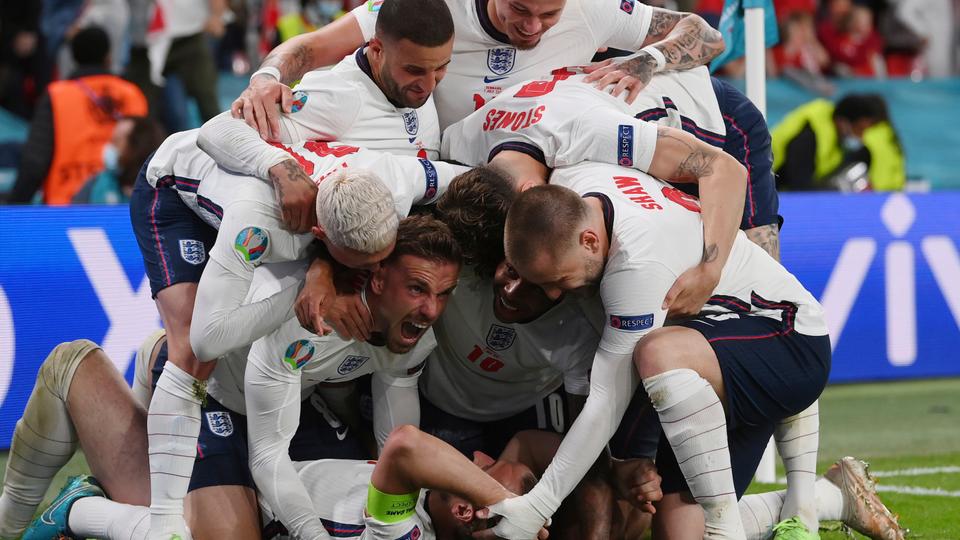 England's Harry Kane, bottom, celebrates with his teammates after scoring his side's second goal during the Euro 2020 football semi-final match between England and Denmark at Wembley stadium in London on July 7, 2021.