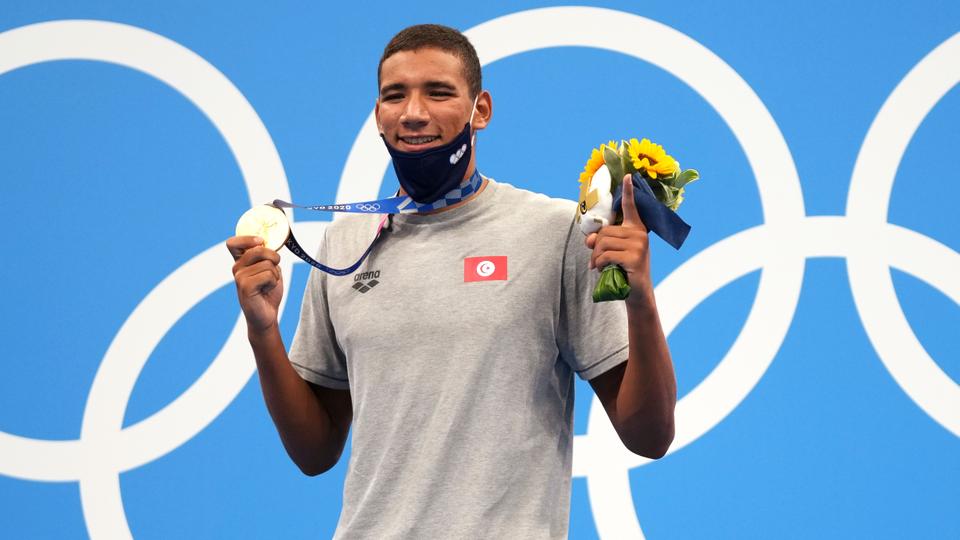 Ahmed Hafnaoui, of Tunisia, poses with his gold medal after winning final of the men's 400-metre freestyle at the 2020 Summer Olympics, July 25, 2021, in Tokyo, Japan.
