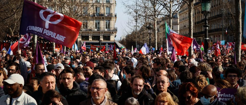 A crowd listen to French far-left candidate for the upcoming presidential election Jean-Luc Melenchon delivering a speech after a march in Paris, Sunday, March 20, 2022.