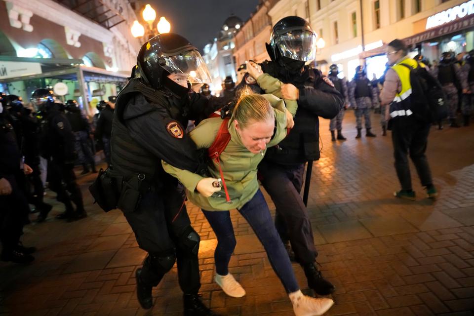 Russian riot police detain a demonstrator during a protest against mobilization, in Moscow, Sept. 21, 2022.