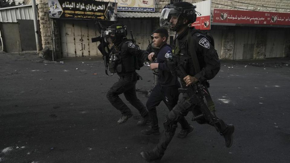 Israeli police arrest a Palestinian in Shuafat refugee camp in occupied East Jerusalem.