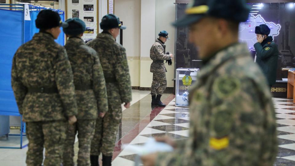 Kazakh army service members queue to cast their votes at a polling station during presidential elections in Almaty, Kazakhstan.