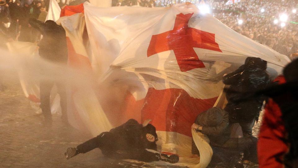 Police use water cannon to disperse protesters during a rally against the
