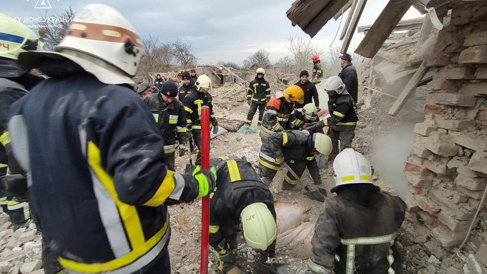 Rescuers work at a site of residential buildings destroyed by a Russian missile strike, amid Russia's attack on Ukraine, in Lviv region.
