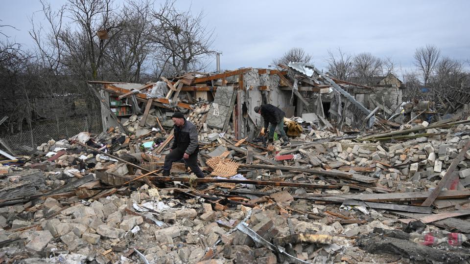 People search the rubble of a house following a Russian strike in the village of Velyka Vilshanytsia, some 50km from Lviv, on March 9, 2023.