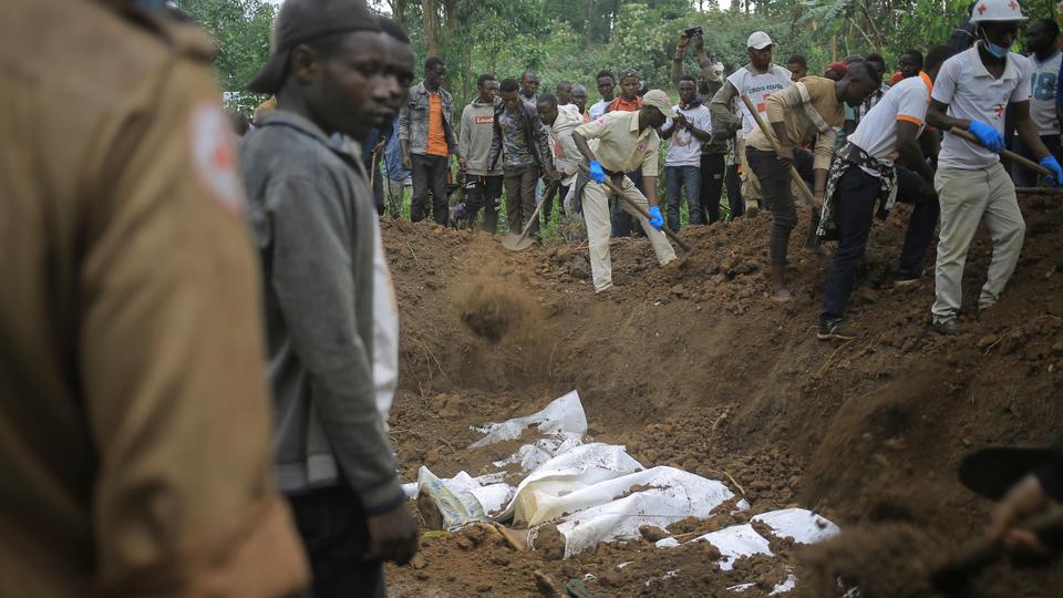 Red Cross volunteers bury remains of civilians killed in North Kivu province village of Mukondi.