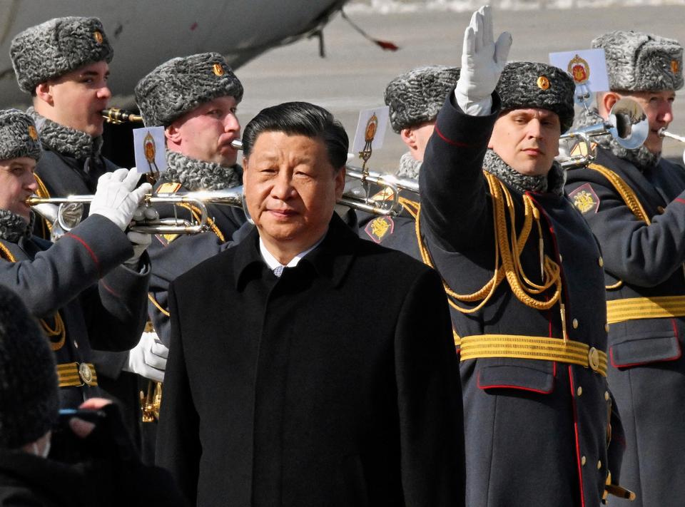 Xi Jinping has been saluted by members of Russian military band in Moscow where he meets Vladimir Putin. Xi wants to increase Chinese clout across the Middle East while cementing partnership with Russia.