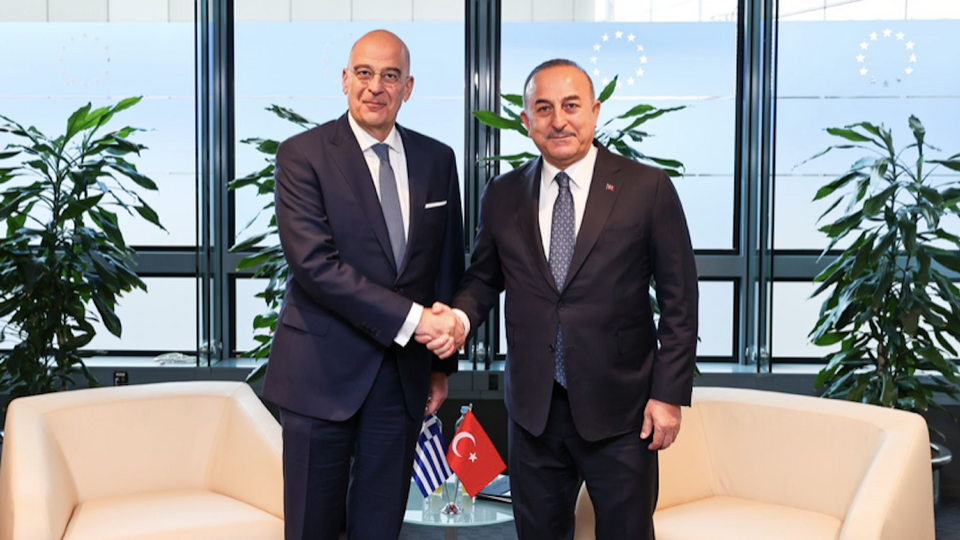 Turkish Foreign Minister Mevlut Cavusoglu (R) and his Greek counterpart Nikos Dendias meet on the sidelines of an international donors' conference in Brussels.