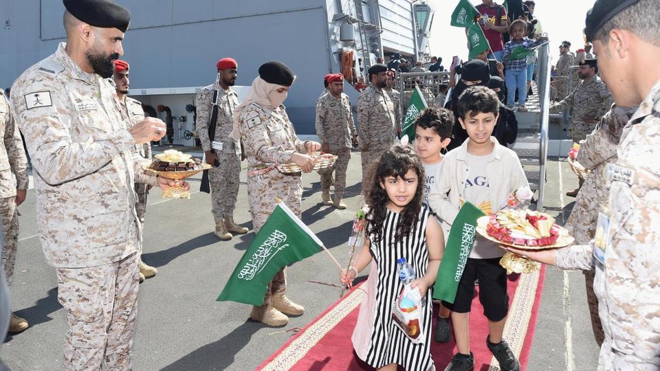 Children are welcomed by Saudi Royal Navy officials as they arrive after being evacuated from Sudan, at Jeddah Sea Port. Photo: Reuters
