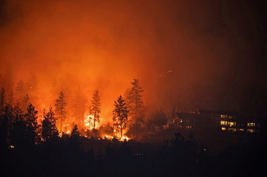 The McDougall Creek wildfire burns next to houses in the Okanagan community of West Kelowna, British Columbia, Canada, Aug. 19, 2023. (Reuters Photo)