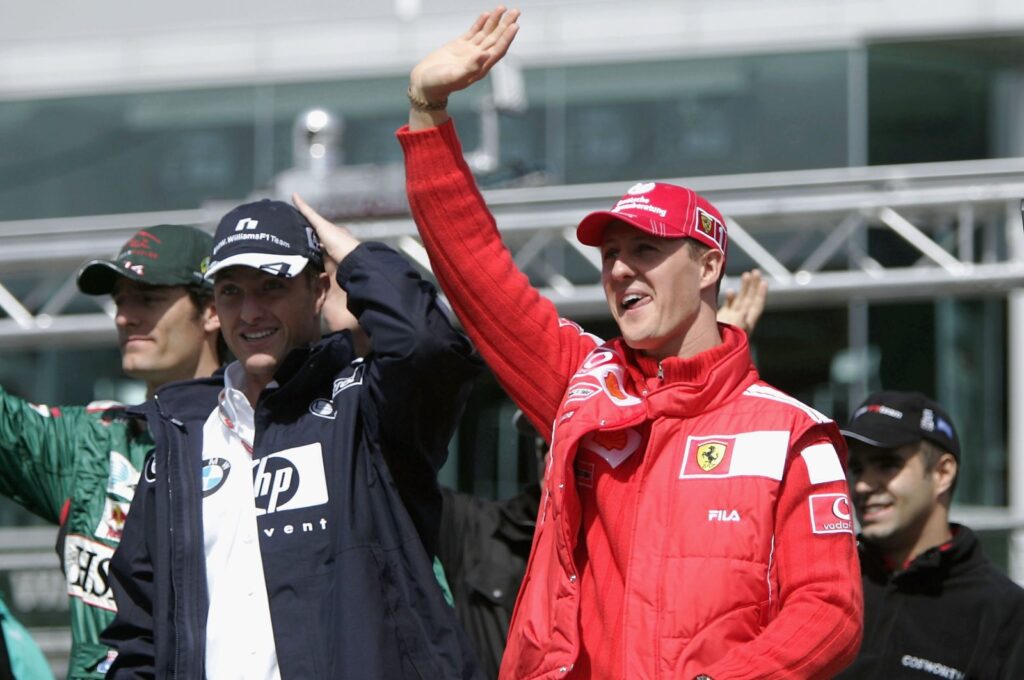 Germany's Michael Schumacher (R) waves with brother Ralf Schumacher during the drivers parade prior to the European F1 Grand Prix, Nurburg, Germany May 30, 2004. (Getty Images Photo)