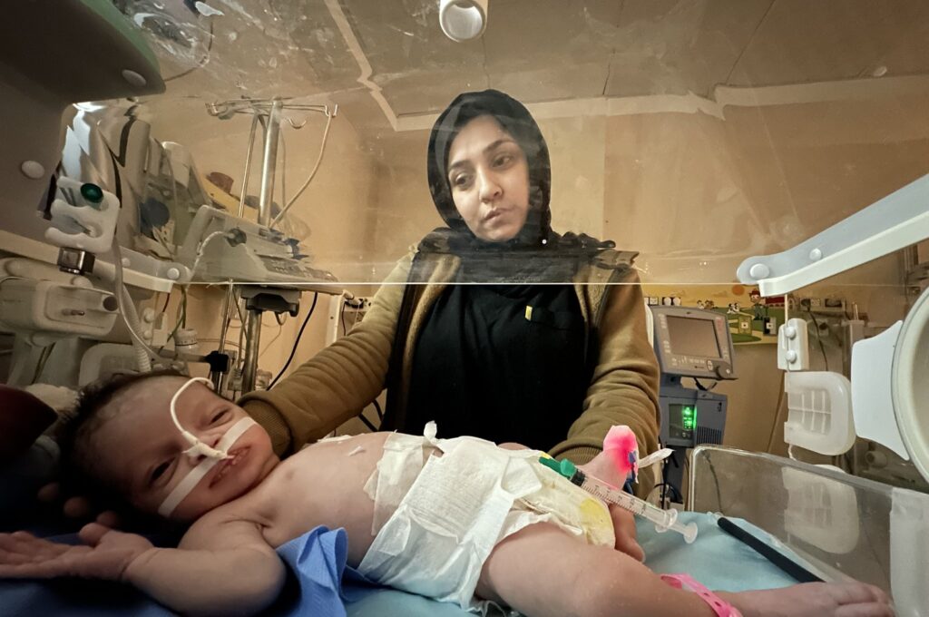 A Palestinian woman looks at a premature baby inside an incubator, the Gaza Strip, Palestine, Jan. 12, 2024. (AA Photo)