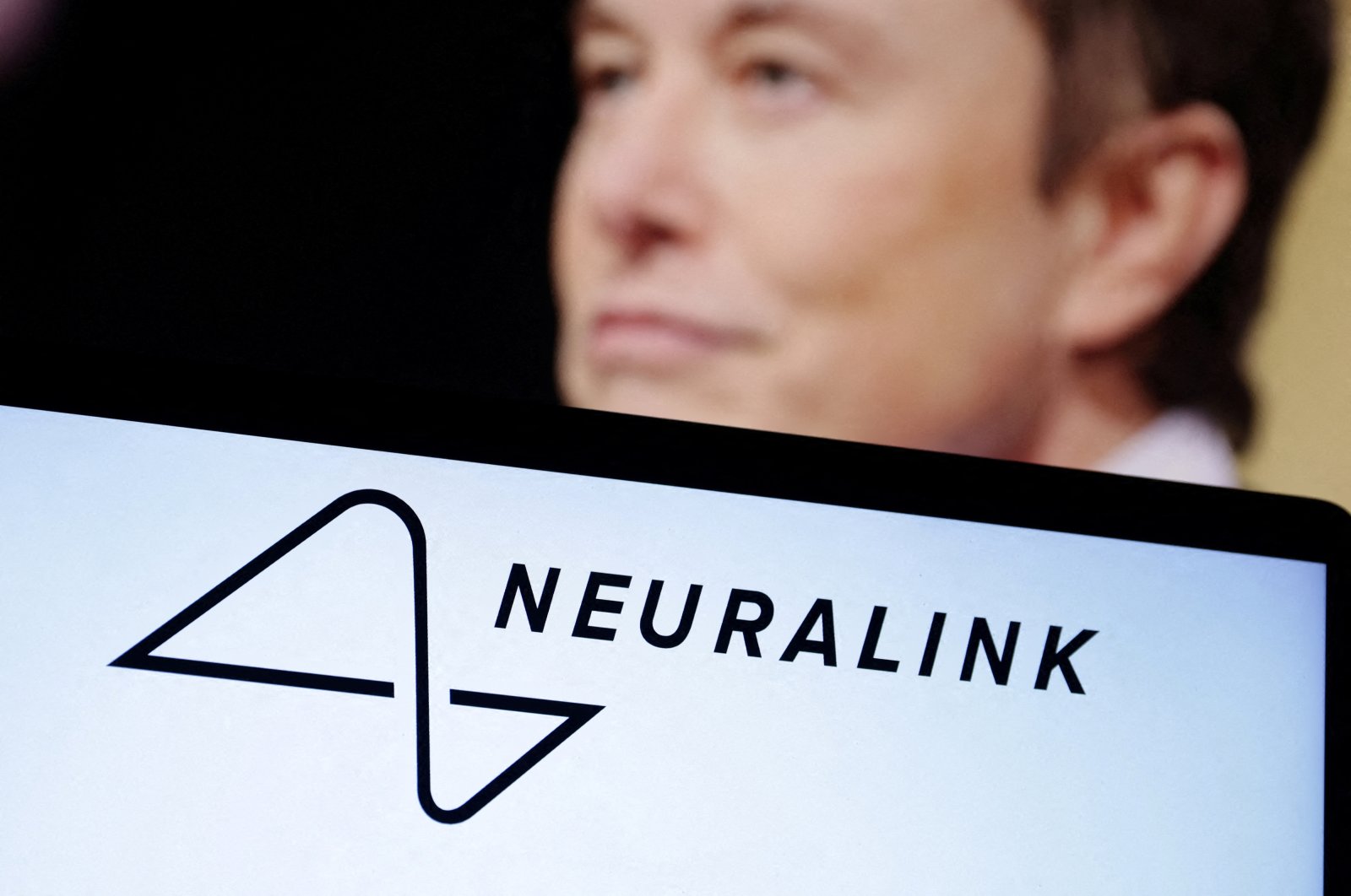 The Neuralink logo and a photo of Elon Musk are seen in this illustration taken Dec. 19, 2022. (Reuters File Photo)