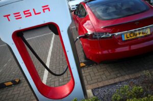 A Tesla car is charged at a Tesla dealership in West Drayton, just outside London, Britain, Feb. 7, 2018. (Reuters Photo)