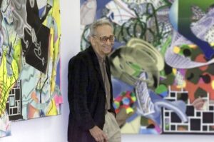 U.S. artist Frank Stella stands between his collages "The Marchioness of O..." (L), and "The Engagement in St. Domingo" at the Wuerttembergischer Kunstverein, Stuttgart, Germany, Sept. 20, 2001. (AP Photo)