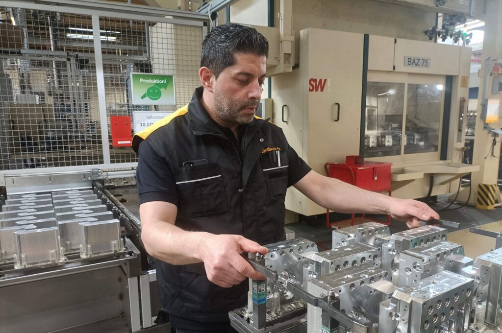 Emrullah Karaca checks hydraulic valve blocks at his workplace at the  Continental Automotive Technologies' plant, Gifhorn, Germany, April 23, 2024. (AFP Photo)