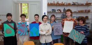 In this undated photo, Turkish artist Zeynep Çilek Çimen is seen with Croatian students holding their artwork, Zagreb, Croatia.  (Photo courtesy of Zeynep Çilek Çimen)
