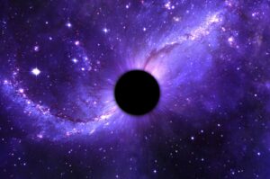 A blackhole surrounded by stars in space. (Shutterstock Photo)