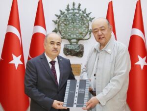 Director of Gimhae National Museum, Yun Hyeung-won, presents a Gimhae National Museum catalog and a gift to Governor Zülkif Dağlı, Çorum, Türkiye, May 21, 2024. (IHA Photo)
